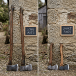 Two long axes and two short axes leaning against a stone wall with chalkboards labeled 'LONG AXES' and 'SHORT AXES'
